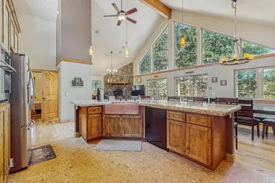 a kitchen with a large island in a room with windows at Elegant Pine in South Lake Tahoe