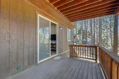a porch of a house with a wooden deck at Elegant Pine in South Lake Tahoe
