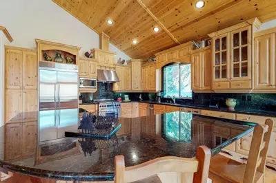 a large kitchen with wooden cabinets and a refrigerator at Brookstone Haven in Truckee
