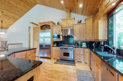 a kitchen with wooden cabinets and a sink and a stove at Brookstone Haven in Truckee