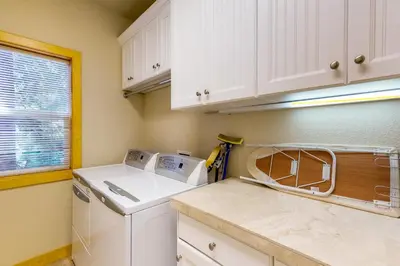 a kitchen with white cabinets and a white dishwasher at Brookstone Haven in Truckee