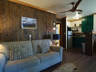 a living room with a couch and a kitchen at Lake Front Cabins in June Lake