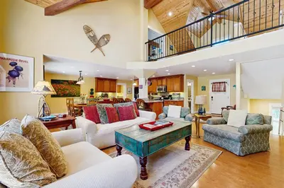 a living room with couches and a table at Cypress Lodge in Arnold