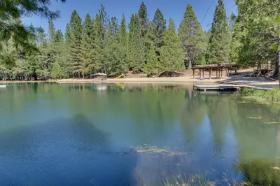 a lake with a dock and a picnic shelter at The Davis Classic in Arnold