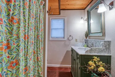 a bathroom with a shower curtain and a sink at Forest Bears Hideout in Arnold