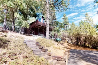 a house on a hill with stairs leading up to it at Forest Bears Hideout in Arnold