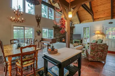 a living room with a wooden ceiling and a dining room at Forest Bears Hideout in Arnold