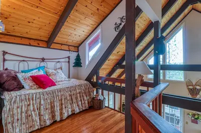 a bedroom with a bed in a room with wooden ceilings at Forest Bears Hideout in Arnold