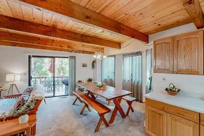 a kitchen and dining room with a wooden ceiling at Mitthas Tapovan in Arnold