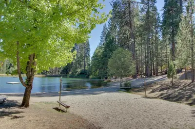 a park with a bench next to a lake at On The 9th in Arnold