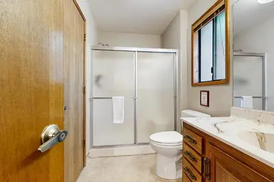 a bathroom with a shower and a toilet and a sink at On The 9th in Arnold