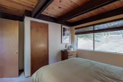 a bedroom with a large bed and a window at Stiles Mountain Hideaway in Arnold