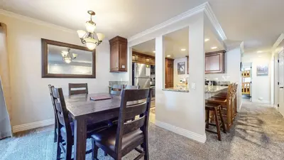 a dining room and kitchen with a wooden table and chairs at Horizons 4 #165 Condo in Mammoth Lakes