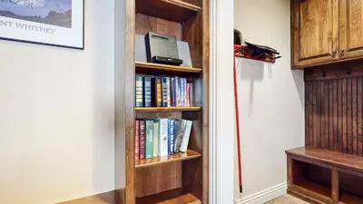 a book shelf in a hallway with books at Horizons 4 #165 Condo in Mammoth Lakes