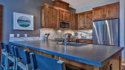 a kitchen with wooden cabinets and a stainless steel refrigerator at Zalanta 319 in South Lake Tahoe