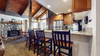 a kitchen with a table and chairs and a fireplace at Horizons Condo 4 #166 in Mammoth Lakes