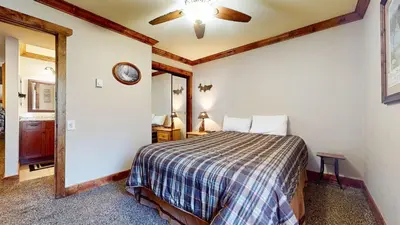 a bedroom with a bed and a mirror at Horizons Condo 4 #166 in Mammoth Lakes