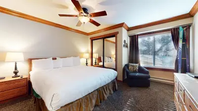 a bedroom with a bed and a ceiling fan at Horizons Condo 4 #168 in Mammoth Lakes