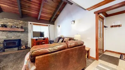 a living room with a leather couch and a fireplace at Horizons Condo 4 #168 in Mammoth Lakes