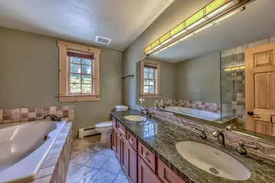 a bathroom with two sinks and a tub and a toilet at R101 Timber Ridge in Kirkwood