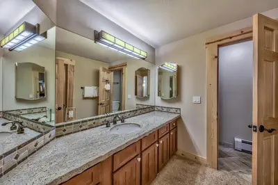 a bathroom with two sinks and a large mirror at R101 Timber Ridge in Kirkwood