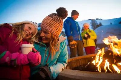 a group of people standing around a fire pit at R101 Timber Ridge in Kirkwood