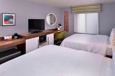 a hotel room with two beds and a desk at Hampton Inn & Suites Carson City in Carson City
