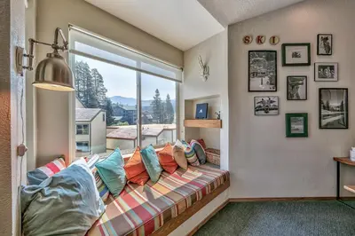 a living room with a couch and a large window at 3302 Sun Meadows in Kirkwood
