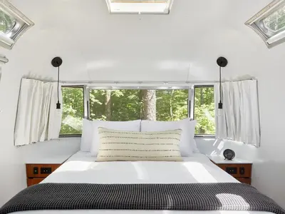 a bedroom with a bed and a bath tub at AutoCamp Yosemite in Midpines