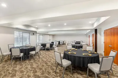 a conference room with tables and chairs in a room at Best Western Plus Villa Del Lago Inn Patterson in Patterson