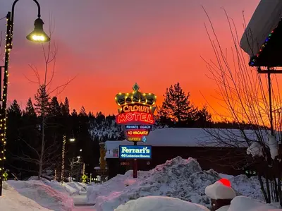 a sign for a casino motel in the snow at Crown Motel in Kings Beach
