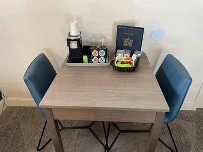 a table with two blue chairs and a box of drinks at Crown Motel in Kings Beach