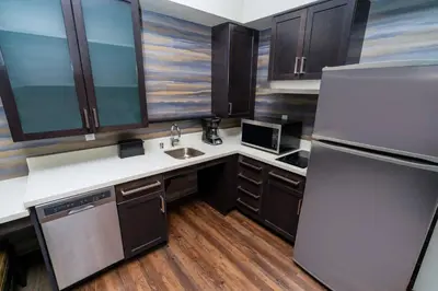 a kitchen with a refrigerator and a sink at Residence Inn by Marriott Rocklin Roseville in Roseville