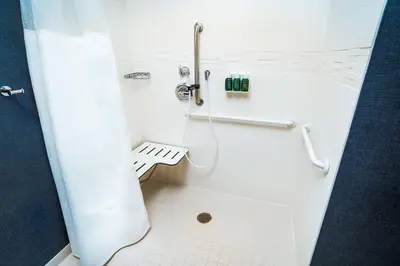 a white bathroom with a shower with a toilet at Residence Inn by Marriott Rocklin Roseville in Roseville