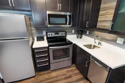 a small kitchen with a stove and a refrigerator at Residence Inn by Marriott Rocklin Roseville in Roseville