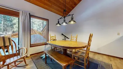 a dining room with a wooden table and chairs at Tennis Village 14 Townhouse in Mammoth Lakes