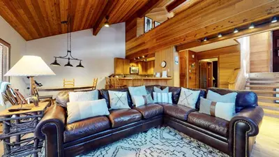 a leather couch in a living room with wooden ceilings at Tennis Village 14 Townhouse in Mammoth Lakes