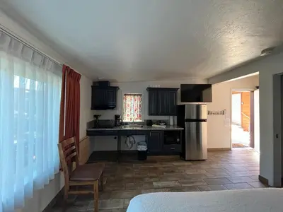 a kitchen with a refrigerator and a table at June Lake Villager in June Lake