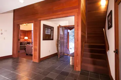 a hallway with wooden walls and stairs in a house at Luxury Lodgepole Home at Northstar in Truckee
