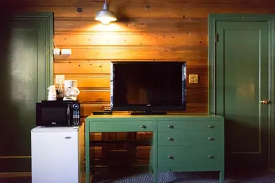a television on top of a dresser in a kitchen at Shaver Lake Village Hotel in Shaver Lake