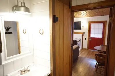 a bathroom with a sink and a mirror at Shaver Lake Village Hotel in Shaver Lake