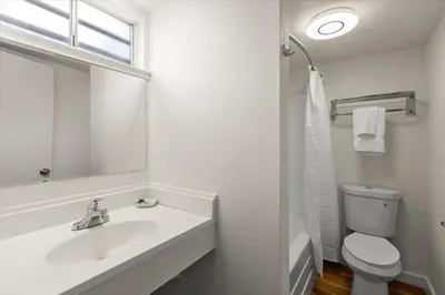 a white bathroom with a sink and a toilet at Ambassador Lake Tahoe in South Lake Tahoe