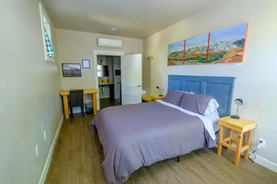 a bedroom with a bed with a purple bedspread at Eastside Guesthouse and Bivy in Bishop