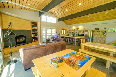 a living room with a couch and a fireplace at Eastside Guesthouse and Bivy in Bishop