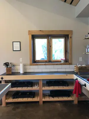 a kitchen with a counter with a bunch of wine bottles at Eastside Guesthouse and Bivy in Bishop
