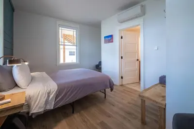 a bedroom with a bed and a window and a door at Eastside Guesthouse and Bivy in Bishop