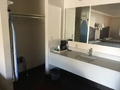 a bathroom with two sinks and a mirror at Portal Motel in Lone Pine