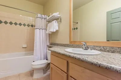 a bathroom with a sink and a toilet and a tub at Sunstone 326 in Mammoth Lakes