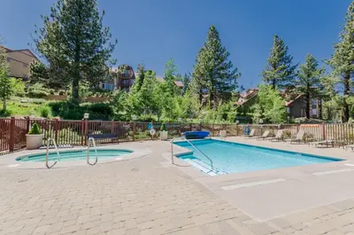 a swimming pool in a yard with a fence at Sunstone 326 in Mammoth Lakes