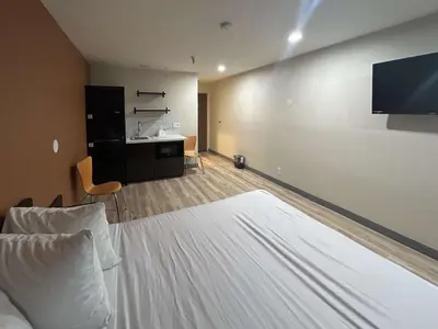 a hotel room with a bed and a tv at Studio 6 Suites Cameron Park, CA Folsom in Cameron Park